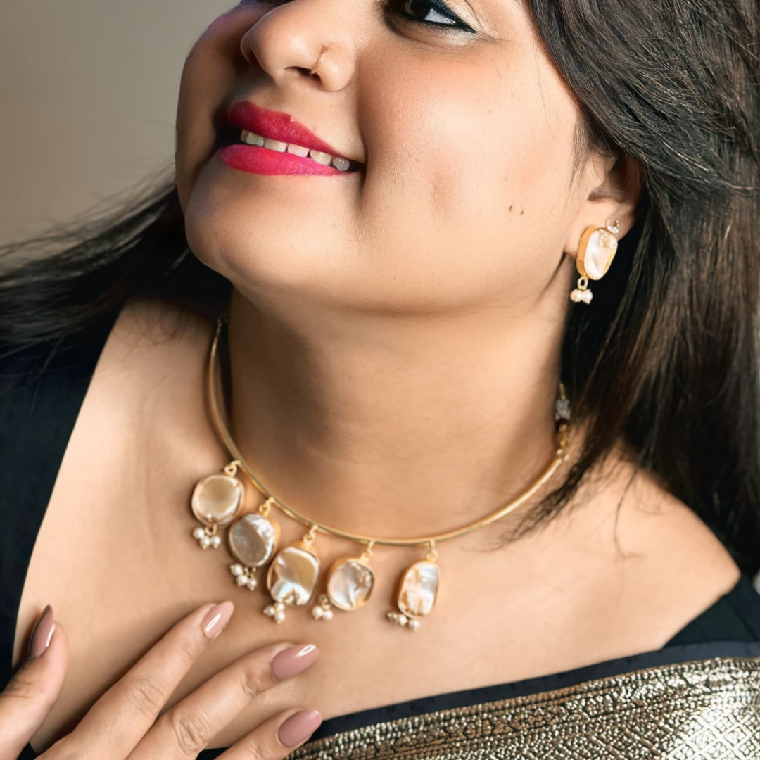 Elegant gold choker set adorned with lustrous drops